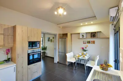 a kitchen and dining room with a table and chairs at Villa Abelizia in Chania Town