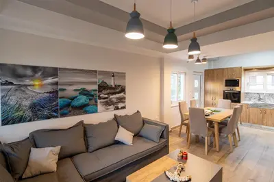 a living room with a couch and a table at Bitsakis Family II - Paleochora Luxury House in Palaiochóra