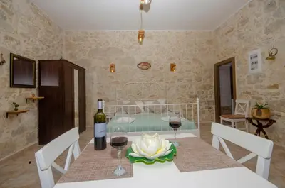 a dining room with a table with two glasses of wine at La casa de Ioanna in Kissamos