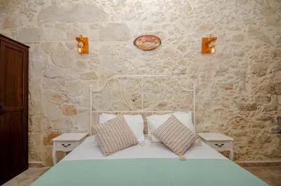 a bedroom with a white bed with two pillows at La casa de Ioanna in Kissamos