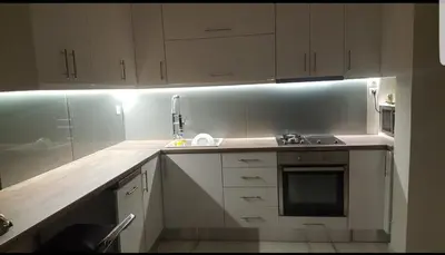 a kitchen with white cabinets and a sink and a stove at Penthouse Apartment in Chania Heart in Chania Town