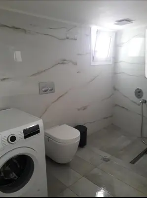 a white bathroom with a toilet and a washing machine at Penthouse Apartment in Chania Heart in Chania Town