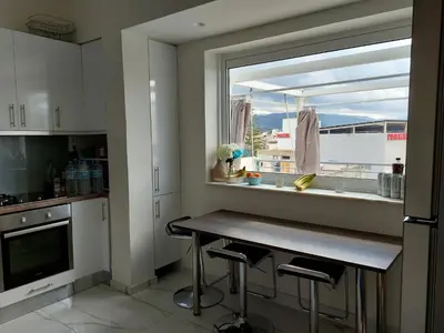 a kitchen with a table and a window with a view at Penthouse Apartment in Chania Heart in Chania Town