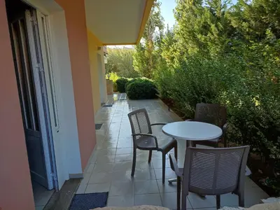 a patio with chairs and a table and a table and chairs at Kyriaki Hotel in Kato Daratso