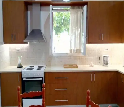 a kitchen with a stove and a window at Kissamos Grandfather's House in Kissamos