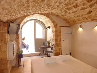 a bedroom with a bed and a large window at Eva Plus in Chania Town