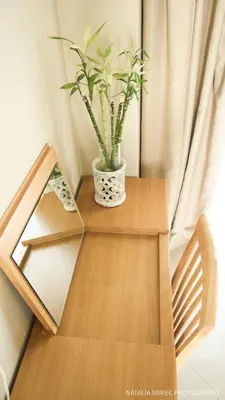 a wooden table with a plant in a vase on it at Alexandra SeaSide Villas in Plataniás