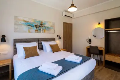 a bedroom with a bed and a desk and a mirror at Bitsakis Family - Paleochora Luxury Villa in Palaiochóra