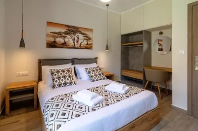 a bedroom with a large bed with two pillows at Bitsakis Family - Paleochora Luxury Villa in Palaiochóra