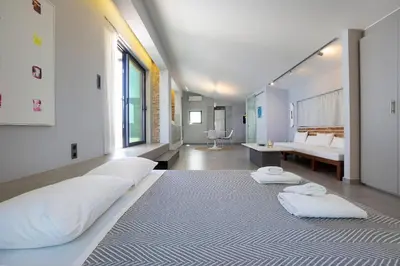 a bedroom with a large bed with two white pillows at Cretan Loft in Plataniás