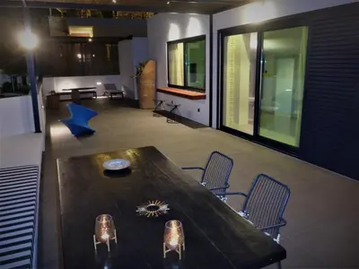 a dining room with a large wooden table and chairs at Cretan Loft in Plataniás