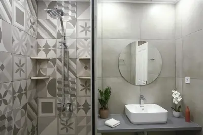a bathroom with a sink and a shower with a mirror at Home with Terrace in Heart of old Town of Chania in Chania Town