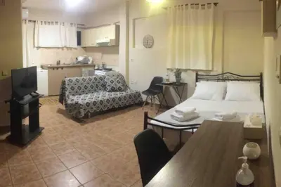 a bedroom with a bed and a couch and a table at Amelie Qute Apartment in Chania Town