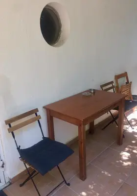 a wooden table and chairs in a room at Amelie Qute Apartment in Chania Town