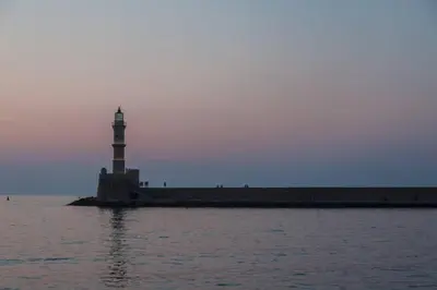 a lighthouse in the middle of a body of water at History and Charm in Chania Town