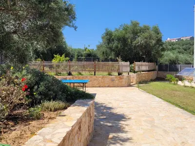 a park with a bench and a table in a yard at Horizon Villa Almyrida in Almirida