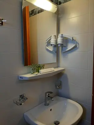 a bathroom with a sink and a mirror at Agia Roumeli Hotel adults only in Agia Roumeli