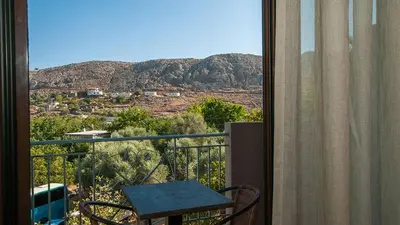a balcony with a table and a view of a mountain at Anopoli Rooms in Anopoli Sfakion