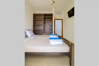 a bedroom with a bed with towels on it at Mantarini House in Áyios Andónios