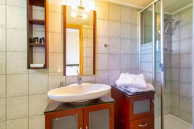 a bathroom with a sink and a shower at Mantarini House in Áyios Andónios