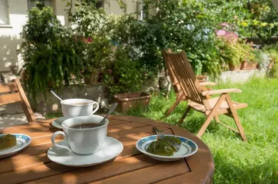 a wooden table with two cups of coffee and plates of food at Peraspitaki in Chania Town