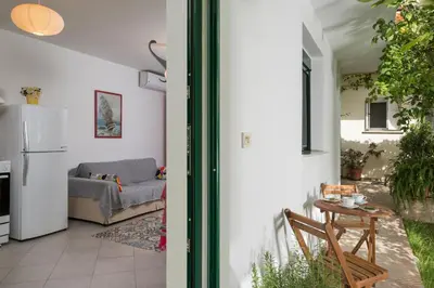 a living room with a couch and a table at Peraspitaki in Chania Town