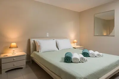 a bedroom with a bed with towels on it at Villa Antoni in Galatás