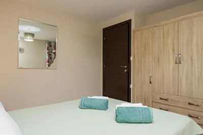 a bedroom with a bed with two blue towels on it at Villa Antoni in Galatás