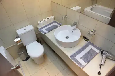 a small bathroom with a sink and a toilet at Oneiro Suites in Souda