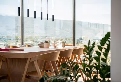 a dining room table with glasses and plants in front of a window at Seametry Luxury Living Penthouse in Souda