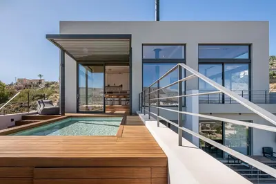 a house with a balcony with a swimming pool at Seametry Luxury Living Penthouse in Souda