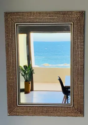 a mirror on a wall with a view of the ocean at Zonapartments B sea view- city center in Chania Town