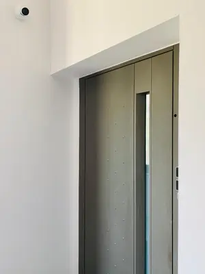 a glass door with a mirror in a white wall at Zonapartments B sea view- city center in Chania Town