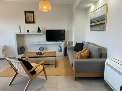 a living room with a couch and a table at Zonapartments B sea view- city center in Chania Town
