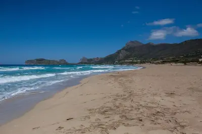 a sandy beach with mountains in the background at Sea & Town Getaway in Chania Town