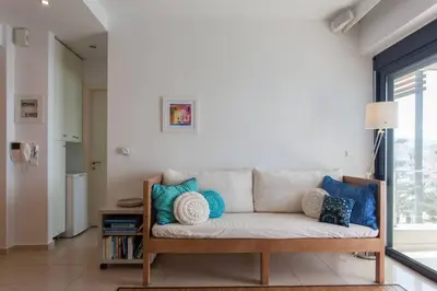 a living room with a couch with pillows on it at Sea & Town Getaway in Chania Town