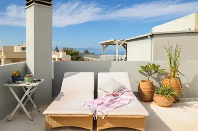 a white chair sitting on top of a balcony at Chania Locals Flat in Chania Town