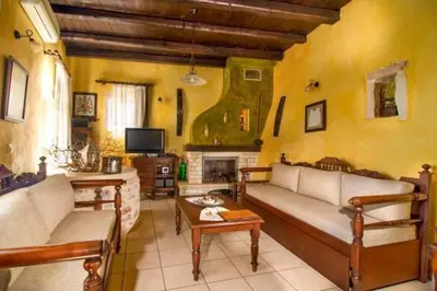 a living room with two couches and a fireplace at Traditional Crete Villa Villa Green Faskomilia Stunning Views 1 Bedroom in Khiliomoudhoú