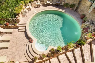 an overhead view of a swimming pool with chairs at Traditional Crete Villa Villa Green Faskomilia Stunning Views 1 Bedroom in Khiliomoudhoú