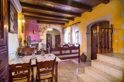 a dining room with a table and chairs in a building at Samonas Traditional Villas Purple Villa Malotira - 85M² Maisonette in Khiliomoudhoú