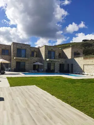 a large brick building with a large swimming pool at Villa Stylianos retreat in Kissamos