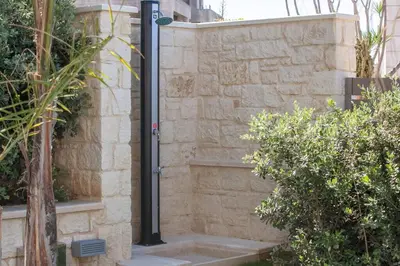 a black pole on a wall next to some bushes at Luxury Villa Crete Villa Marina Mare 3 Bedroom Private Pool in Chania Town