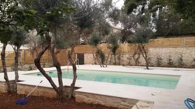 a swimming pool in a yard with trees around it at Luxury Crete Villa Villa Koukounari Private Pool Beautiful Scenery in Chania Town