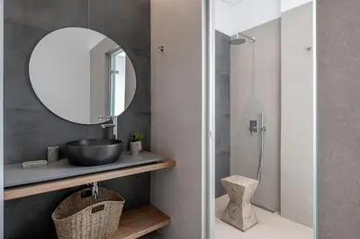 a bathroom with a sink and a mirror at Anthos Villas - Chania in Tavronitis