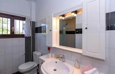 a white bathroom with a sink and a toilet at Exclusive Crete Villa Villa Alexia 4 Bedrooms Large Lawned Gardens in Maleme