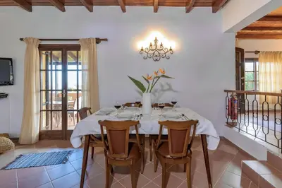 a dining room with a table and chairs at Exclusive Crete Villa Villa Alexia 4 Bedrooms Large Lawned Gardens in Maleme