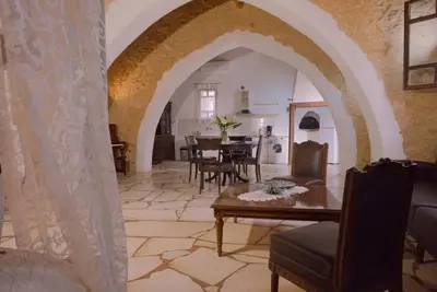 an archway in a living room with a table and chairs at Villa Kamares Private pool in Kondomari