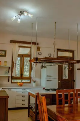 a kitchen with a table and a dining room at Villa Kalamitsi Luxury Villa in Apokorona Chania in Kariá