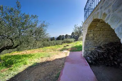 a stone bridge with a path under it at Casa Rustica in Xirokámbion