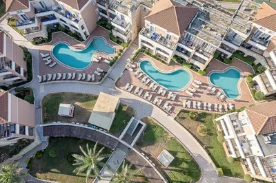 an aerial view of a resort with two water slides at Caldera Beach in Plataniás